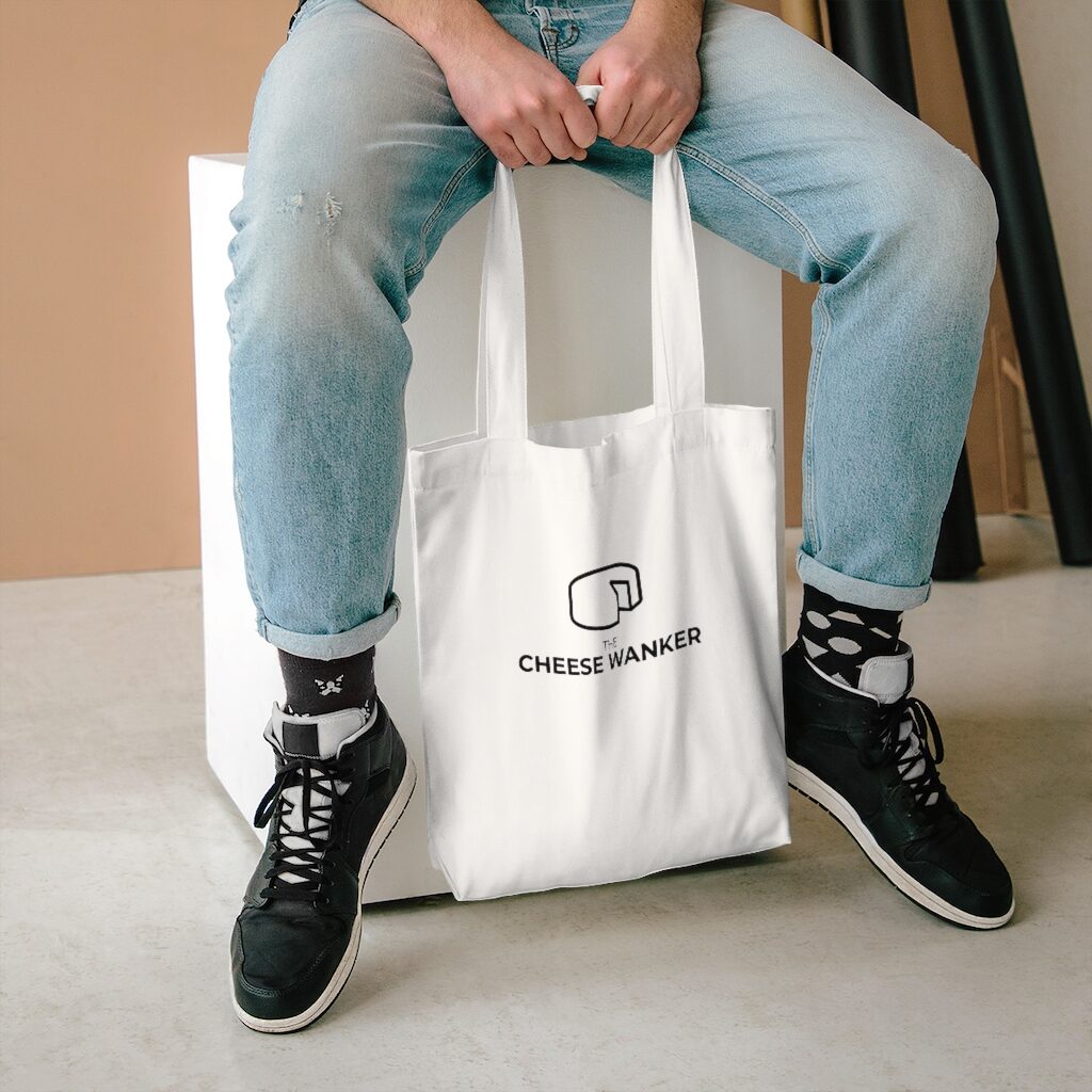 White The Cheese Wanker Logo Bag - Lifestyle Male Model Sitting