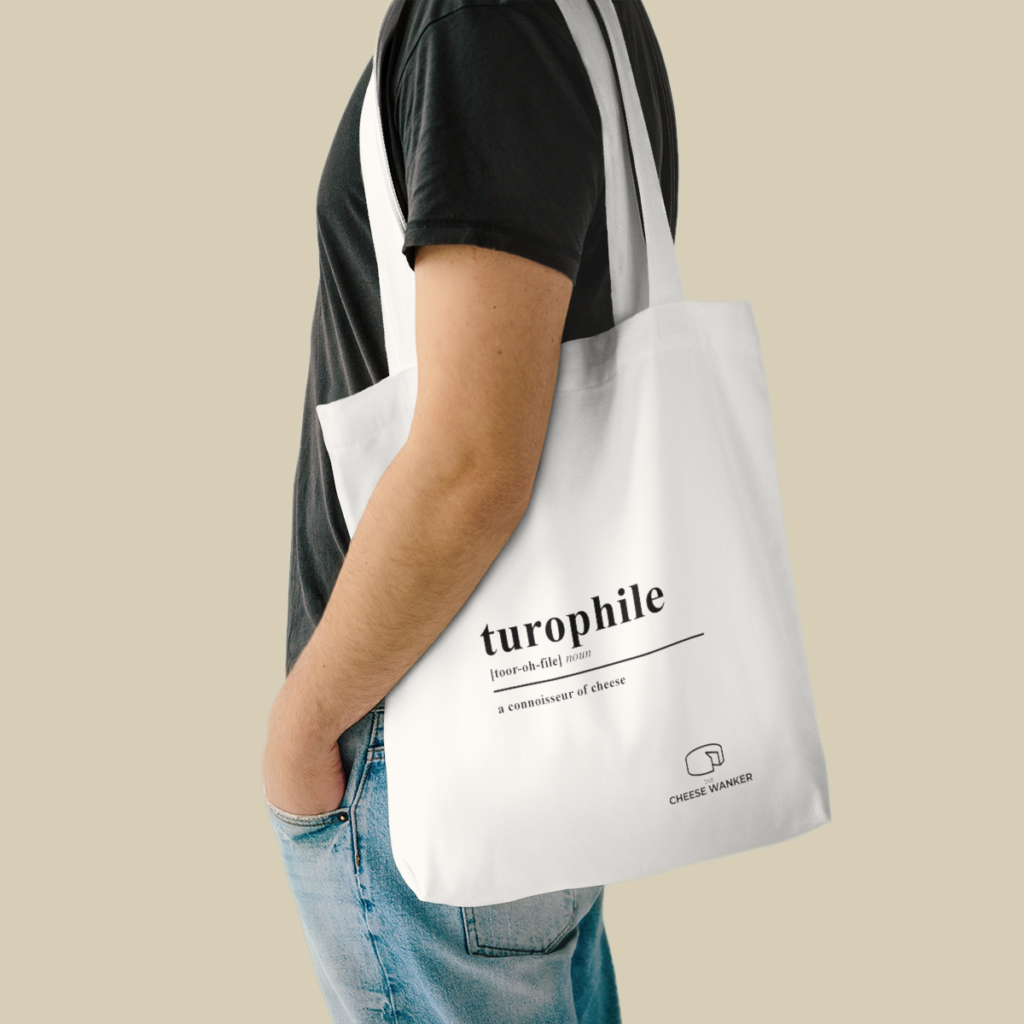 Male cheese lover carrying white Turophile market bag on his shoulder