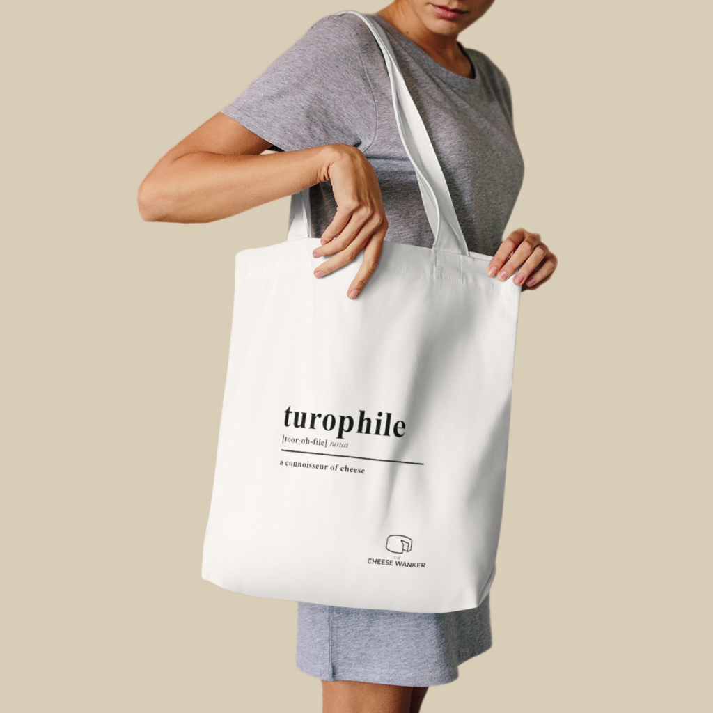 Female cheese lover carrying white Turophile market bag on her shoulder