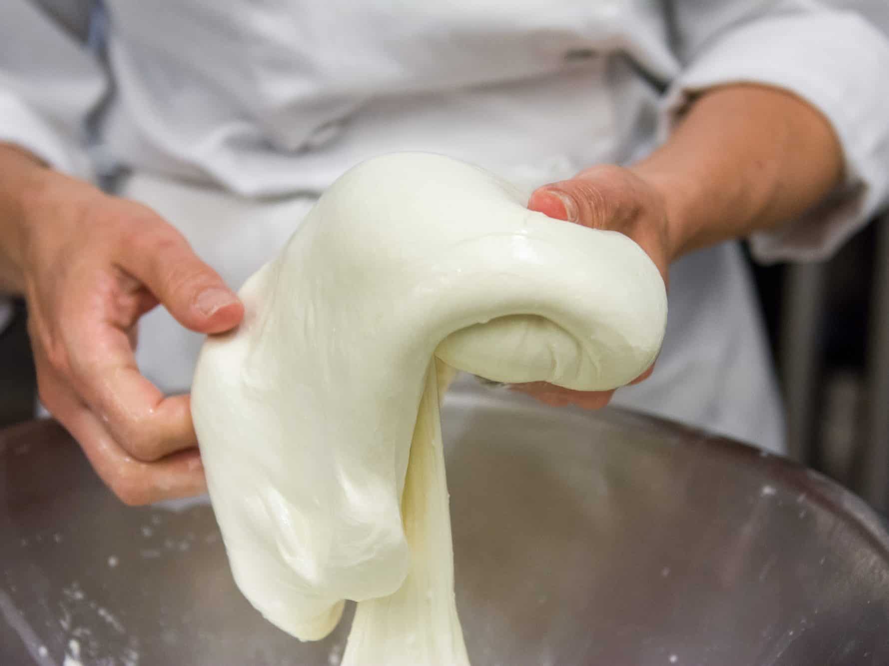 stretching curd to make mozzarella by hand