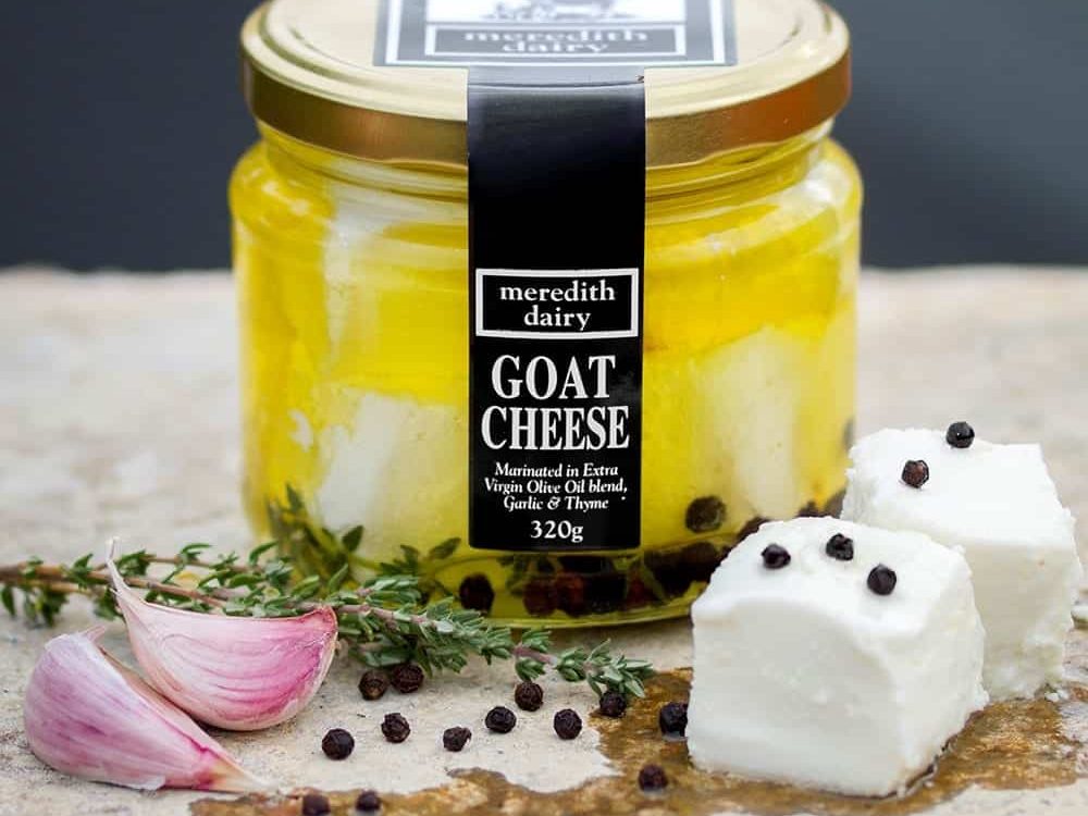Cubes of white goat cheese in oil