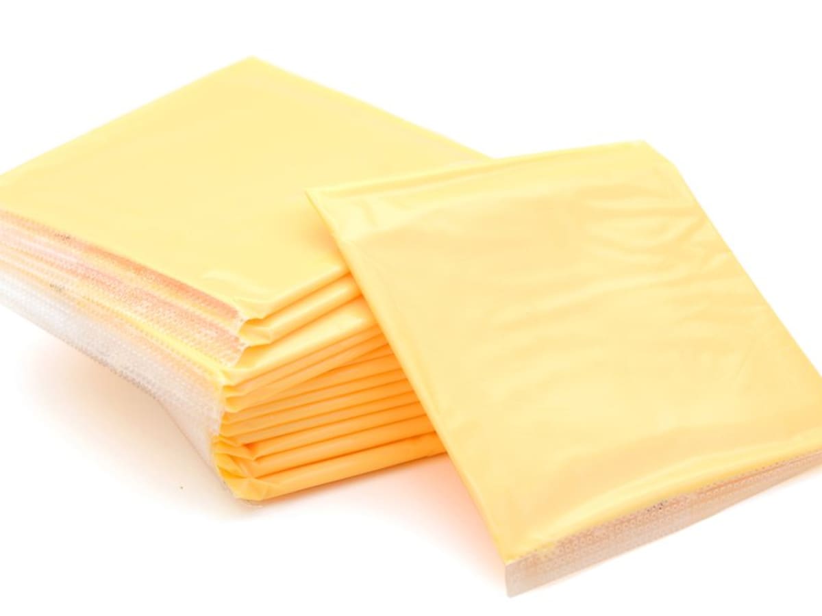 Individual sheets of processed cheese wrapped in plastic
