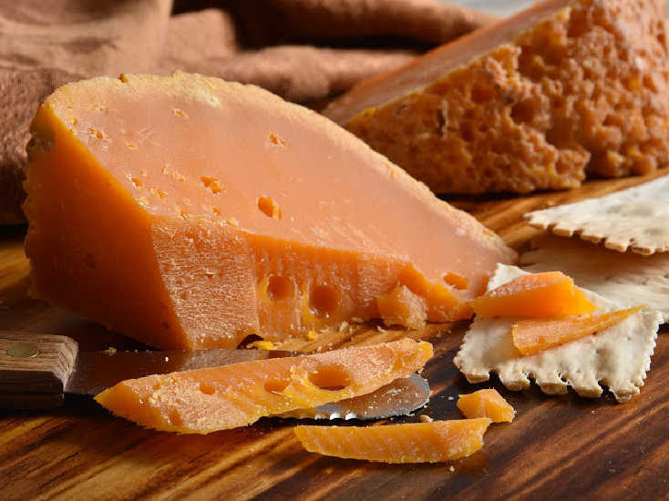 Crumbly orange raw milk Mimolette with natural rind
