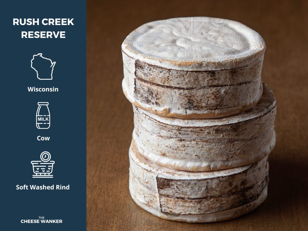 Stack of 3 Rush Creek Reserve small round cheeses wrapped in spruce bark