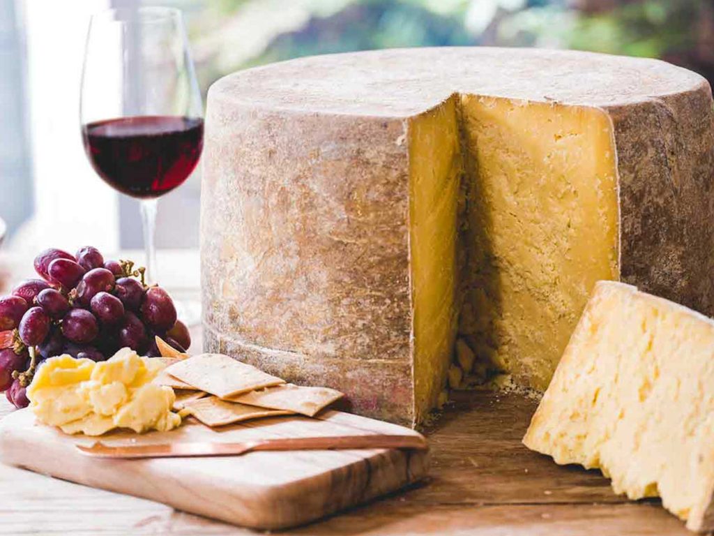 Pyengana Clothbound Cheddar with glass of red wine and grapes