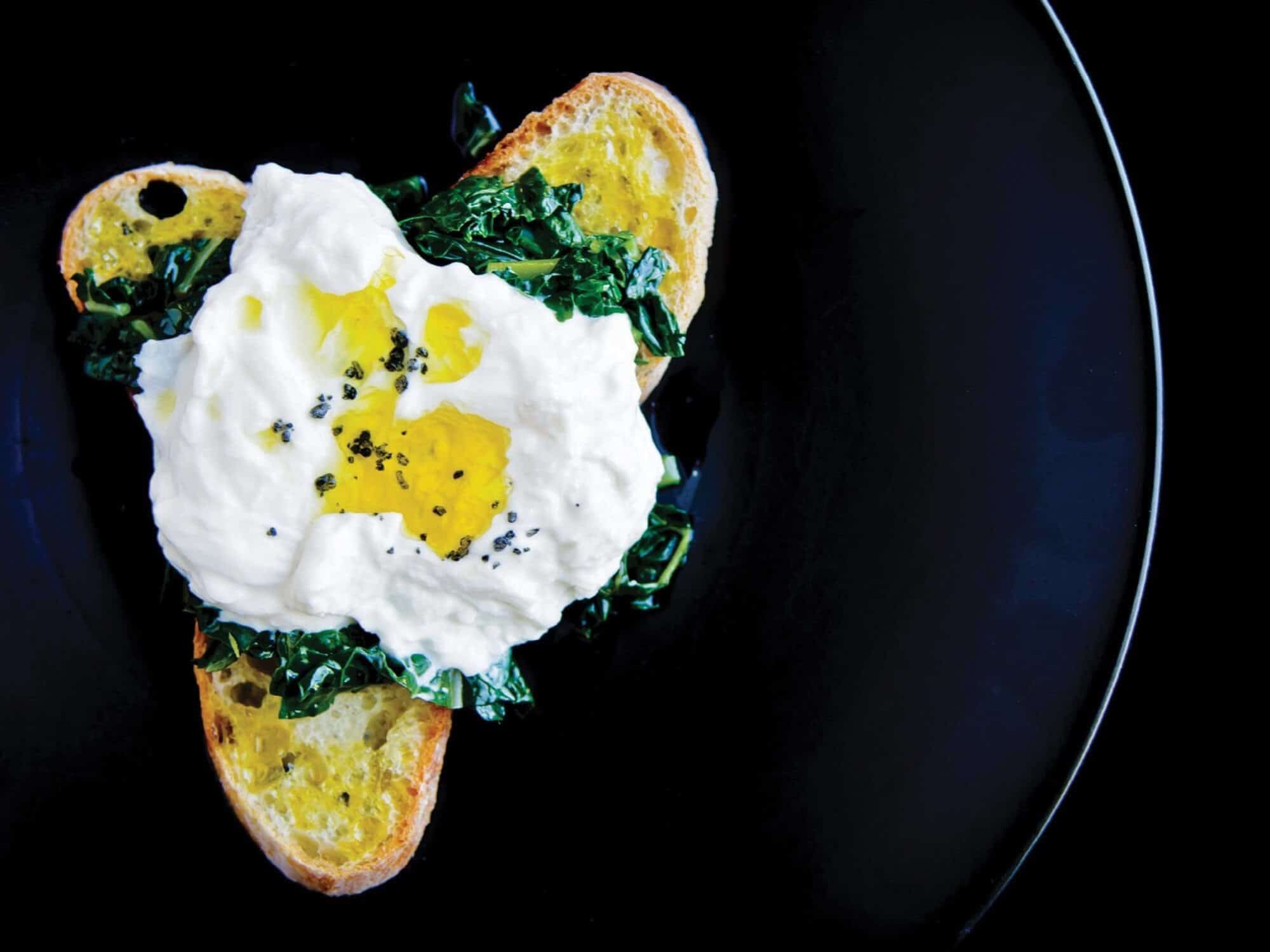 Simple Burrata dish with cheese on crunchy bread and olive oil