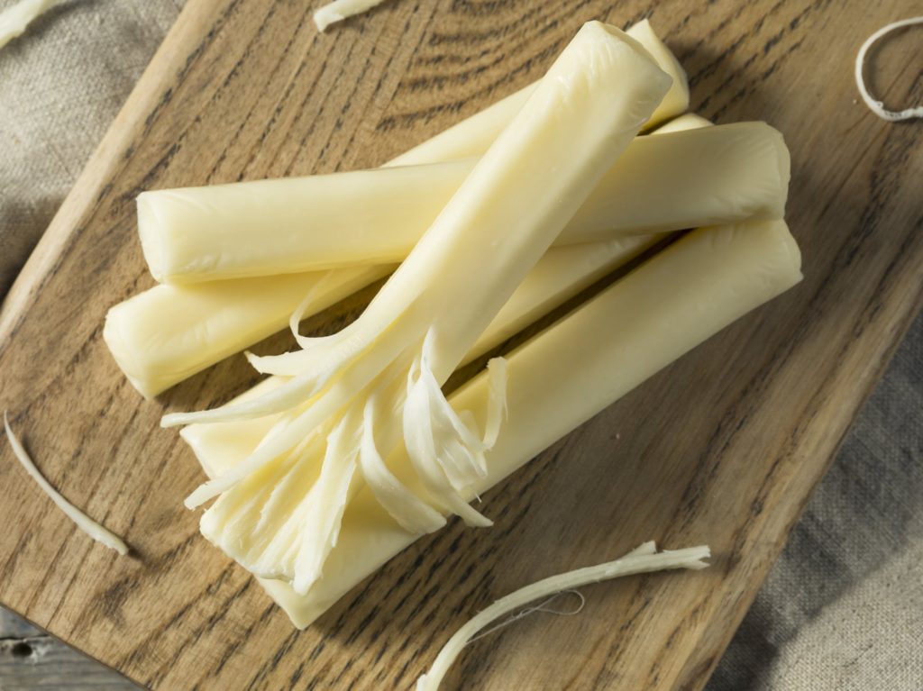 Commercial String Cheese on a wooden board