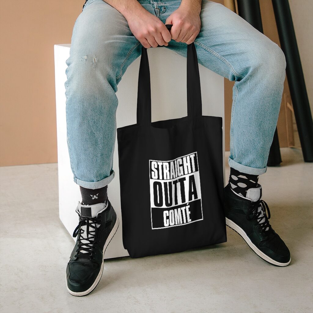 Straight Outta Comté Market Bag Lifestyle Male Model Sitting - Black