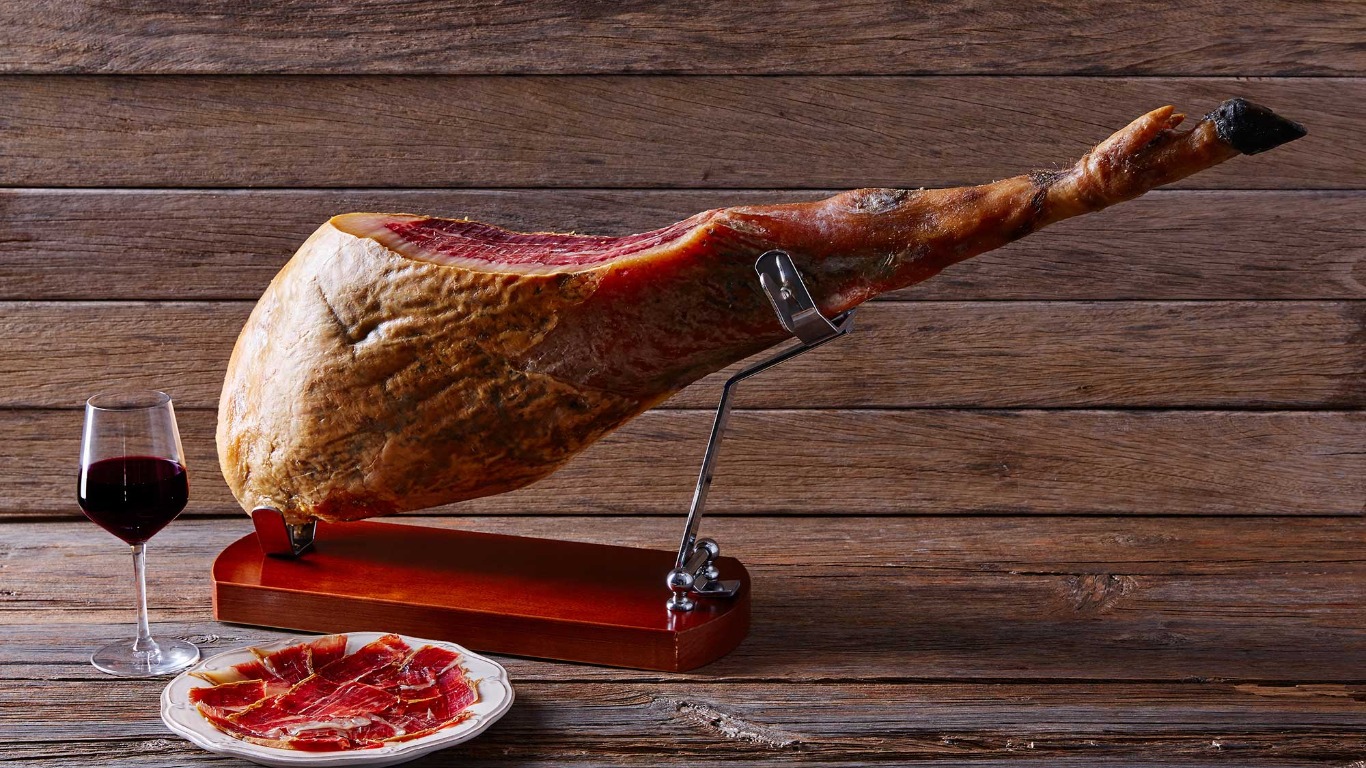 Leg of Jamon sliced and served with glass of red wine