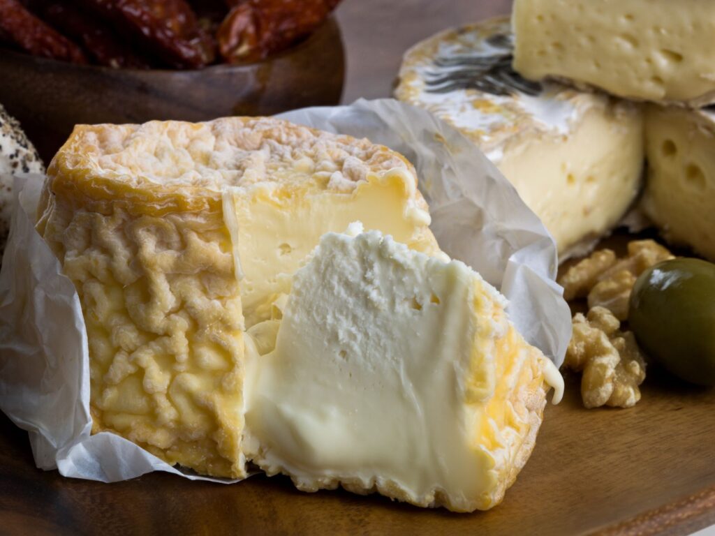 Oozy ripe Langres cheese with orange wrinkly rind