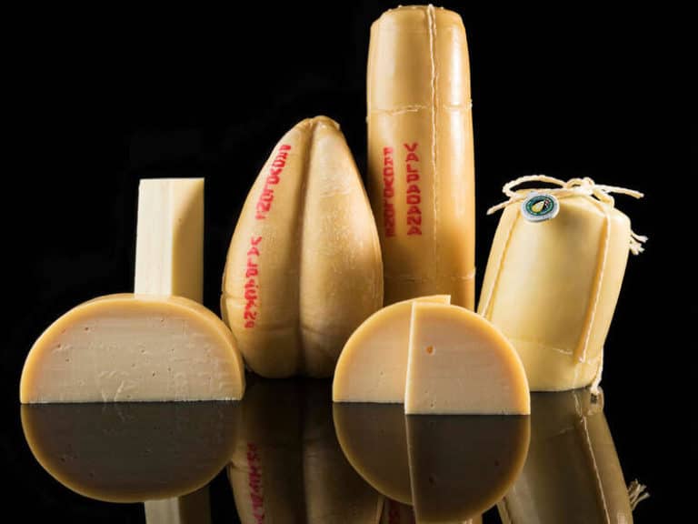 Range of Provolone cheese against dark background