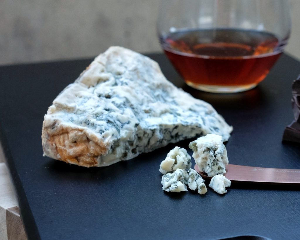 Tasmania's Sapphire Blue cheese on a board with a tumbler of whisky