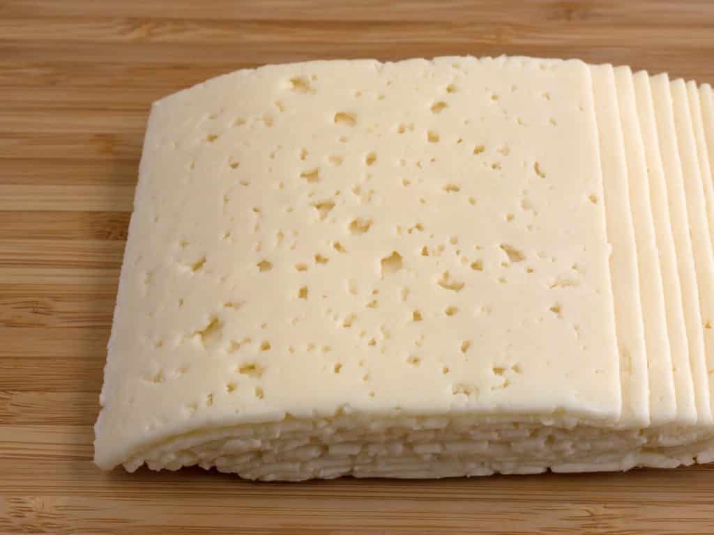 Slices of Havarti Danish Cheese with tiny holes