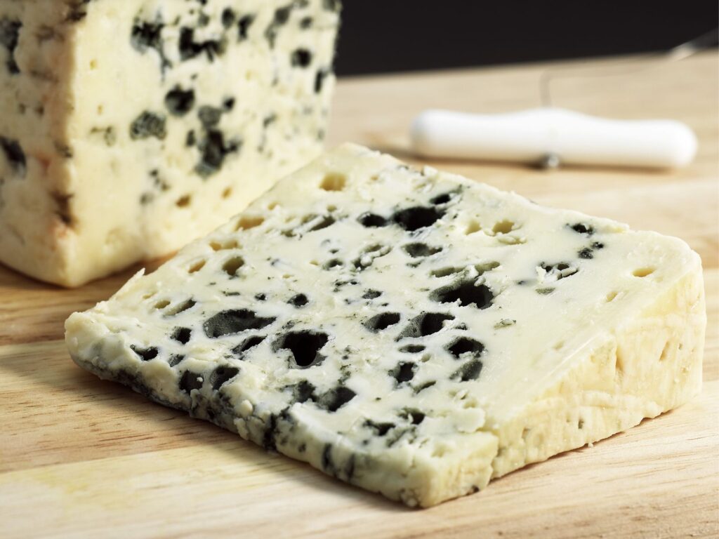 Wedge of Roquefort blue cheese