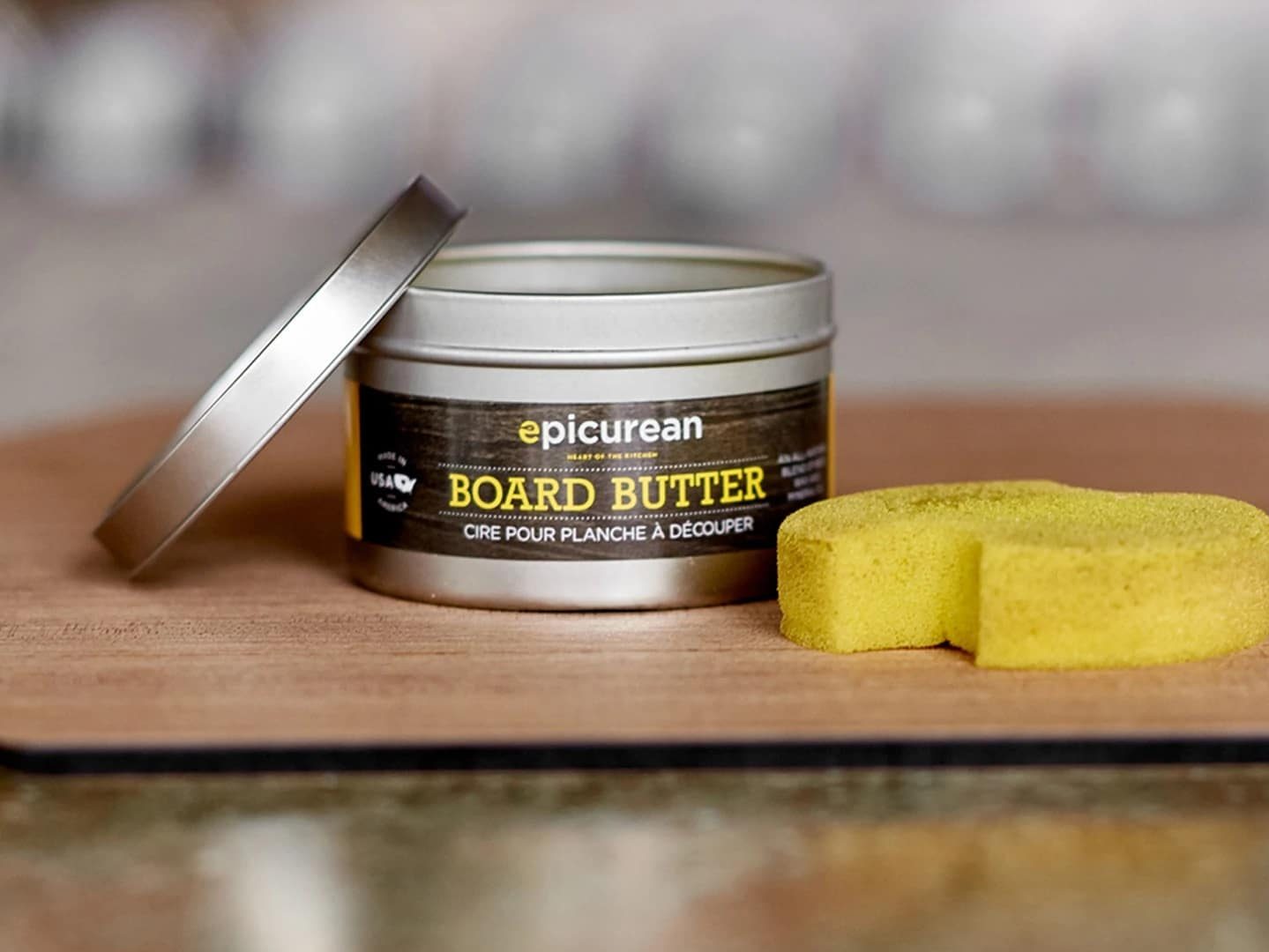 Tin of Epicurean Wood Butter on a wooden board