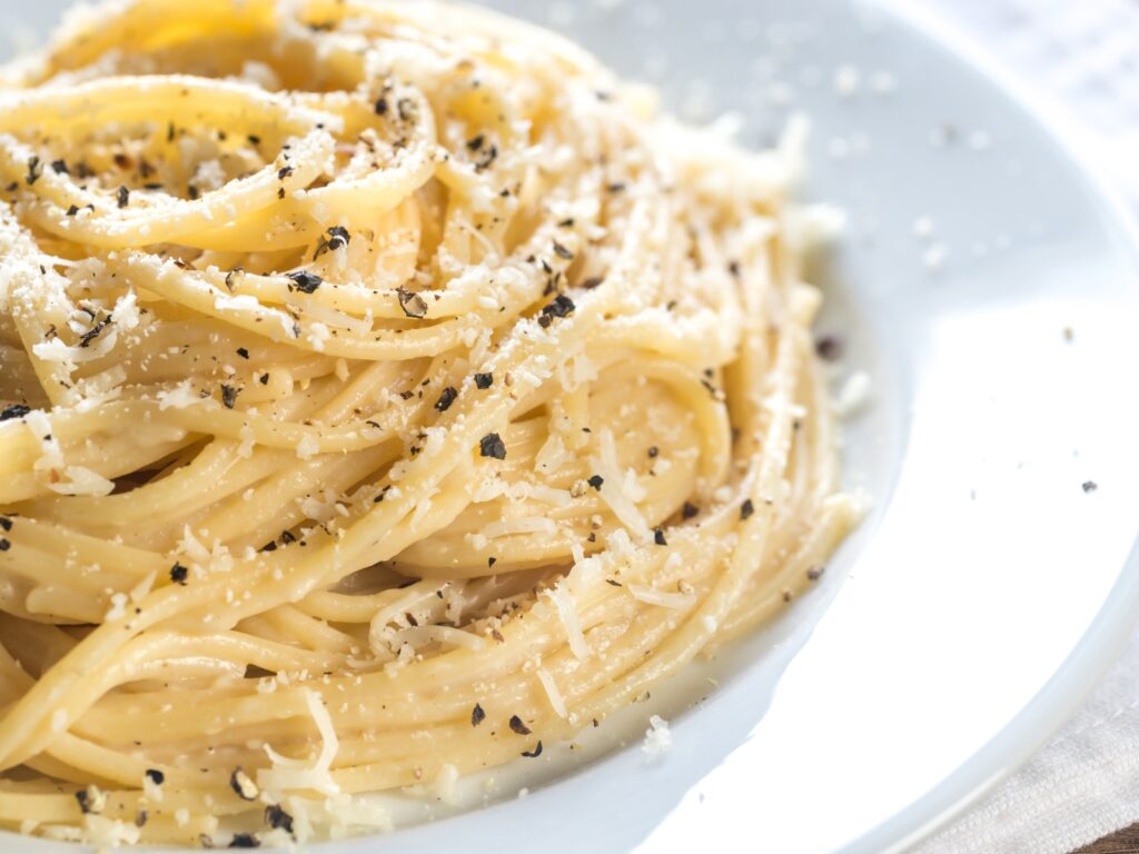 Parmigiano Reggiano grated on pasta