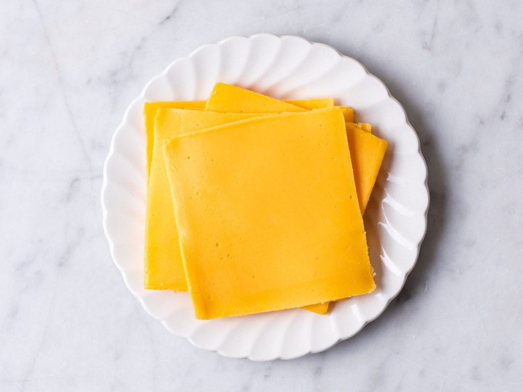 Slices of American Cheese on a white plate