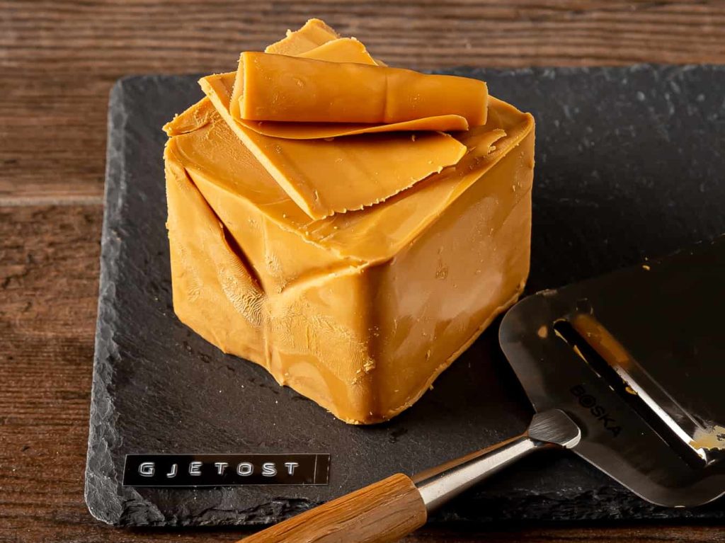 Norwegian brown cheese Gjetost on a slate board