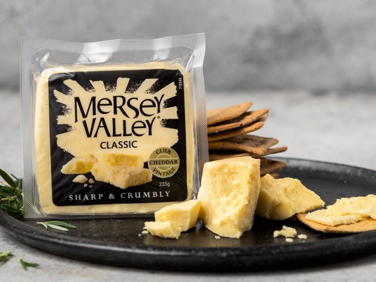 Block of Mersey Valley Classic cheese on black plate