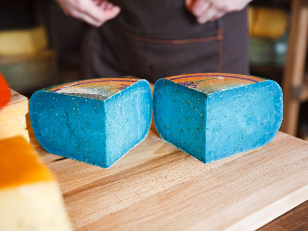 Blue pesto Gouda cheese on chopping board