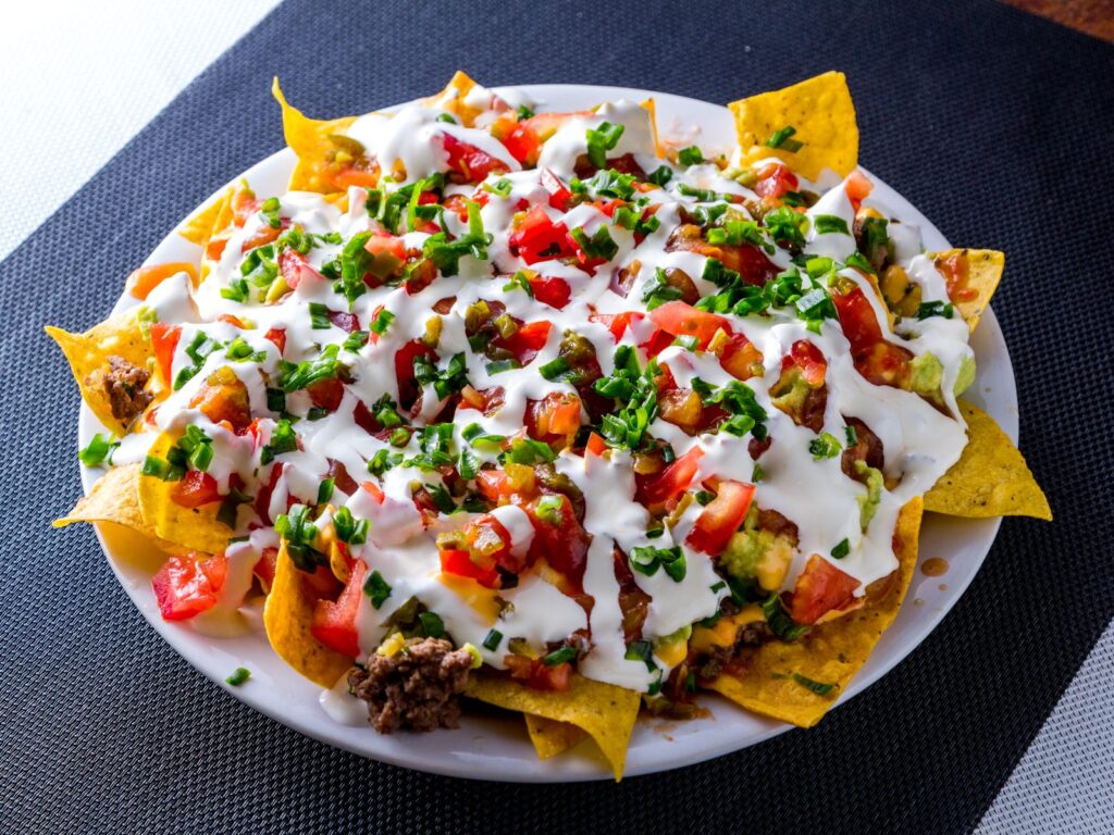 Loaded nachos on a white plate