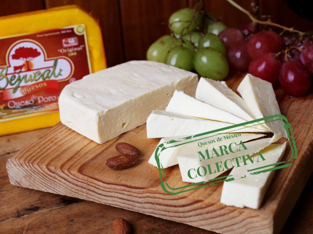 Queso de Poro cheese sliced on a wooden board