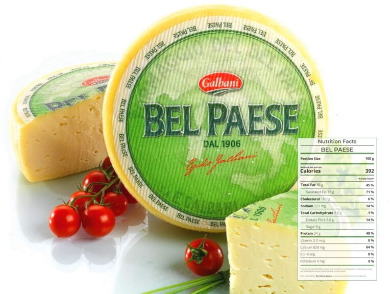 Wheel of Bel Paese cheese with green label against white background