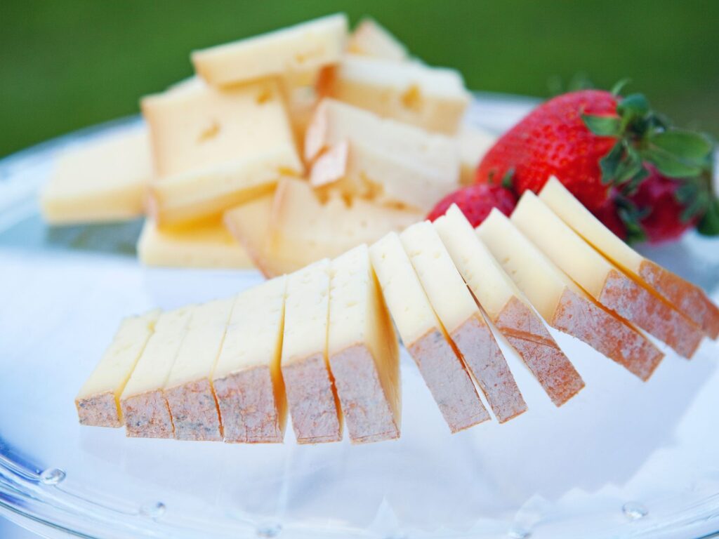 Plate of sliced semi-soft Fontina cheese