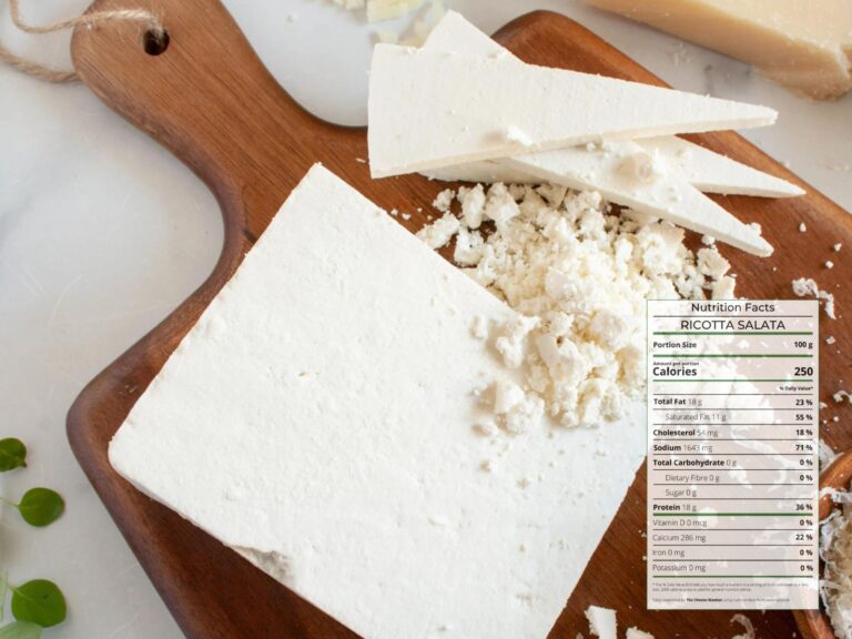 Crumbly wedge of white hard cheese Ricotta Salata cut into slices on wooden board with nutrition facts overlaid
