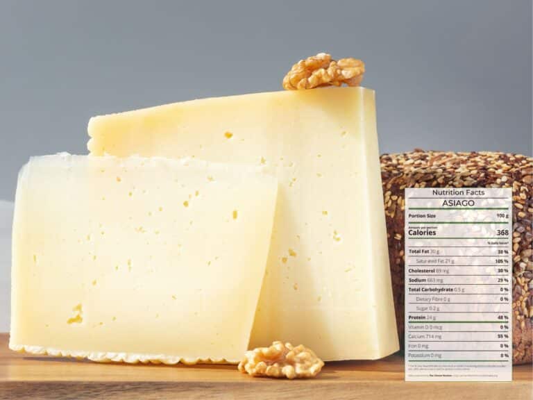 Wedge of white Italian cheese Asiago on a wooden board with walnut and nutrition facts overlaid