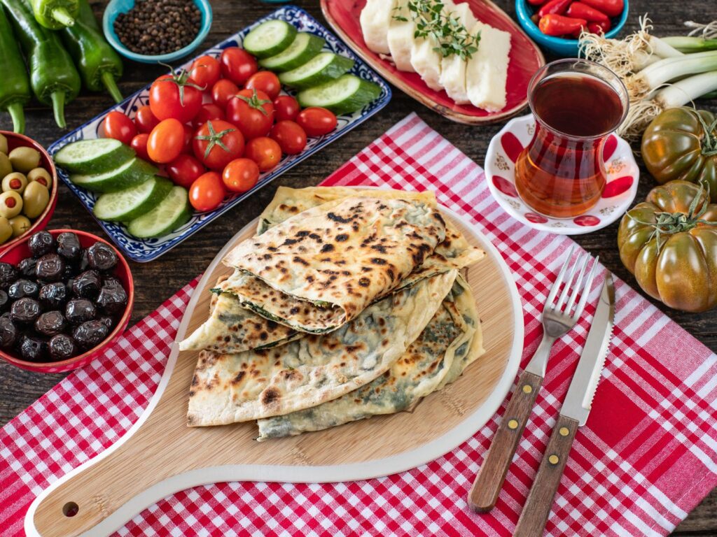 Peynirli Gözleme on a wooden paddle board (Turkish Cheese Dish)