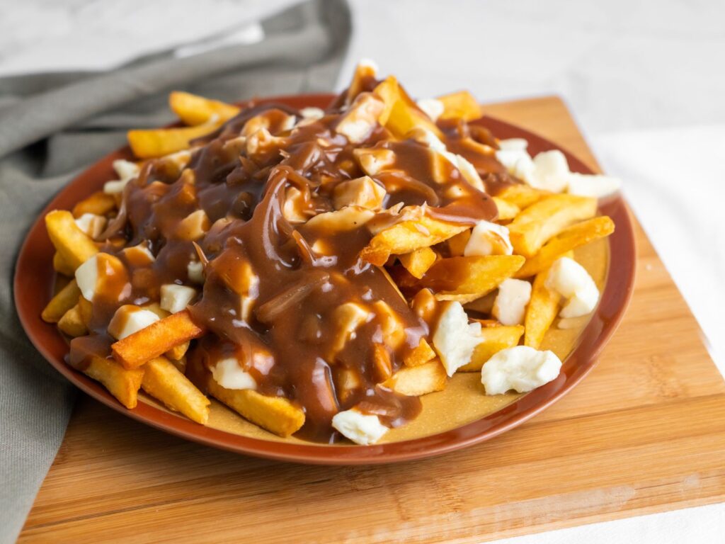 Plate of Canadian Poutine with fries, cheese curds and gravy