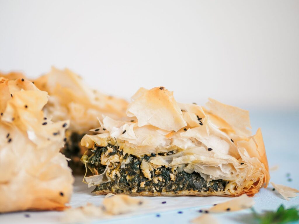 Delicate Greek phyllo pastry cheesy dish Spanakopita on a white plate