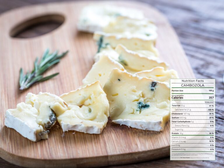 Slices of creamy blue cheese Cambozola spread on a wooden board with nutrition facts overlaid