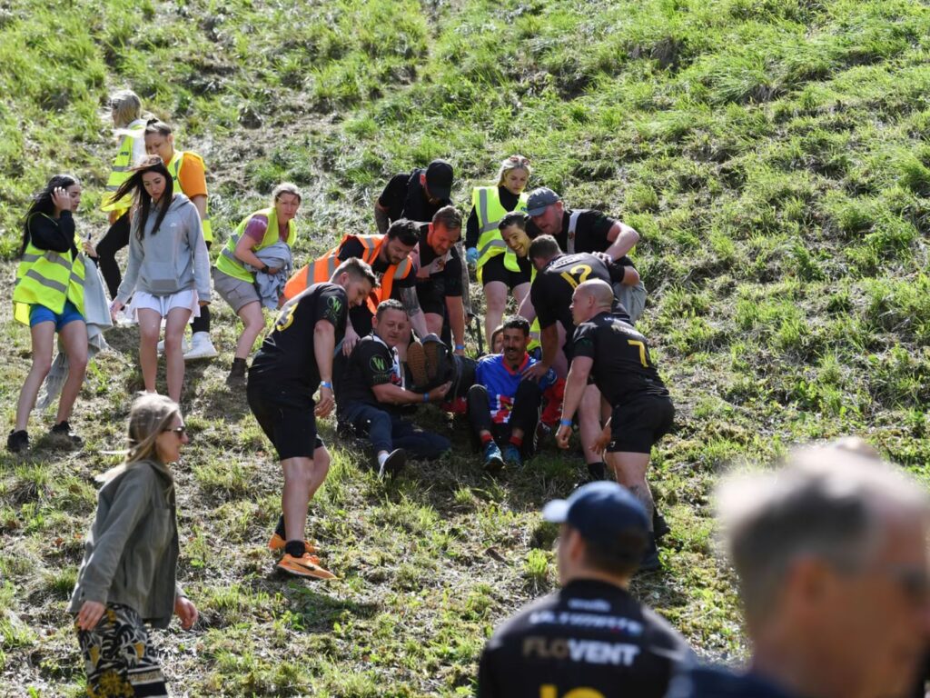 Cooper's Hill Cheese Rolling Festival Injured man attended to by ambulance team 