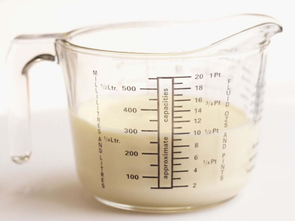 Glass Measuring Cup full of milk