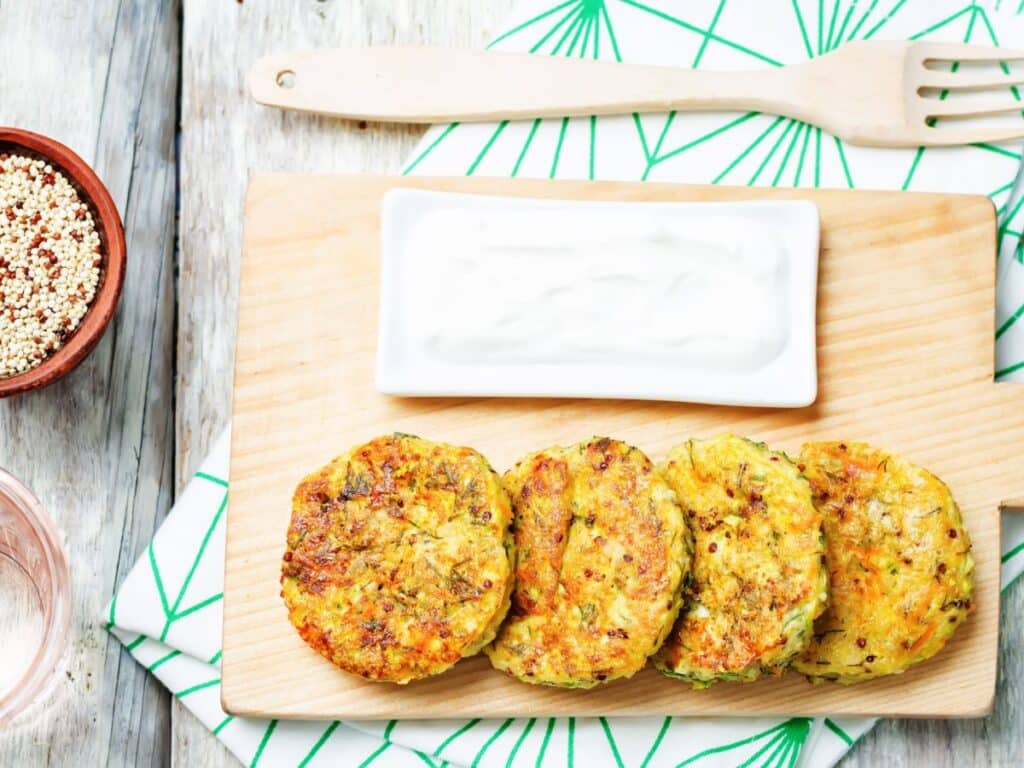 Feta and Zucchini Fritters on wooden serving platter
