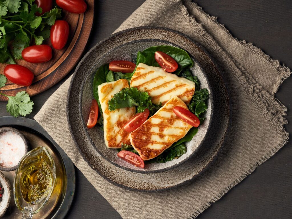 Grilled Halloumi Salad with tomatoes and spinach on a plate